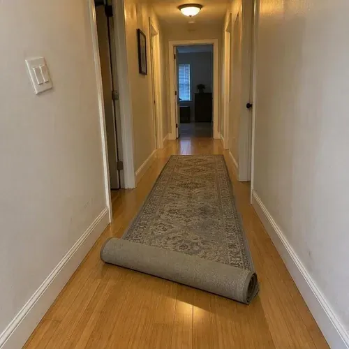 Finished bamboo hallway with rolled runner rug after bamboo floor installation
