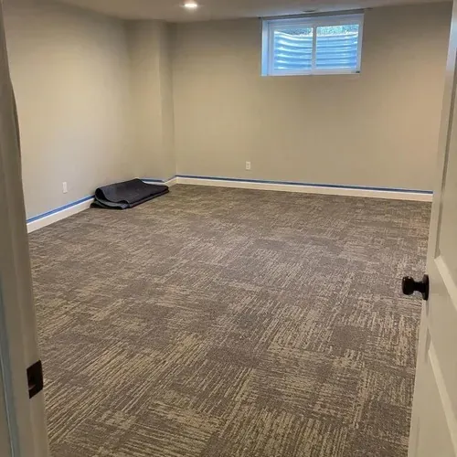 New patterned carpet in basement rec room after carpet installation