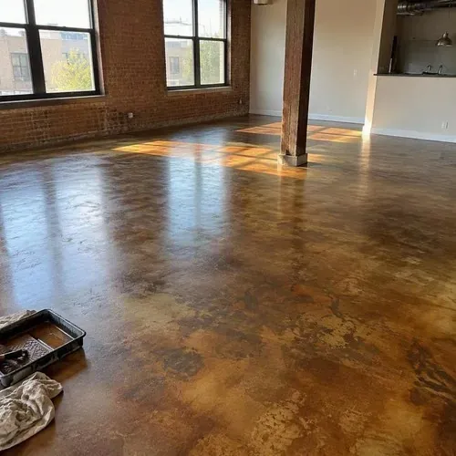 Acid-stained brown concrete floor in loft after concrete polishing and coating