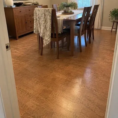 Finished floating cork floor under dining table after cork floor installation