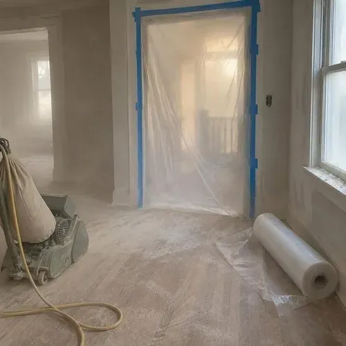 Plastic sheeting over doorways during dusty sanding, part of hardwood floor sanding and refinishing