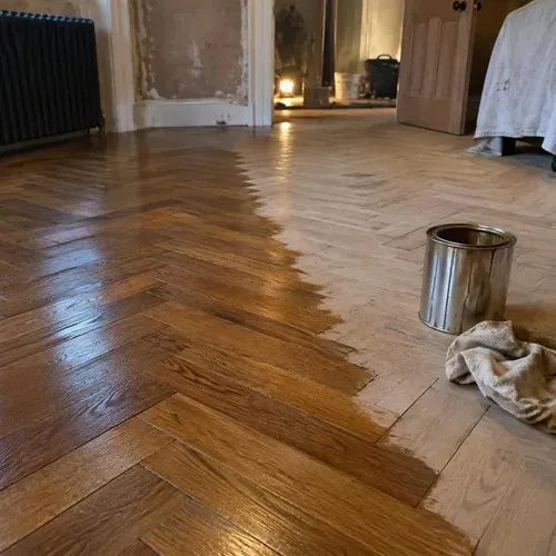 Sanded herringbone floor half oiled during herringbone and parquet floor installation