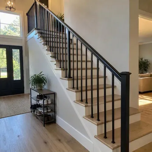 Finished stairs with black metal spindle railing after stair and railing installation